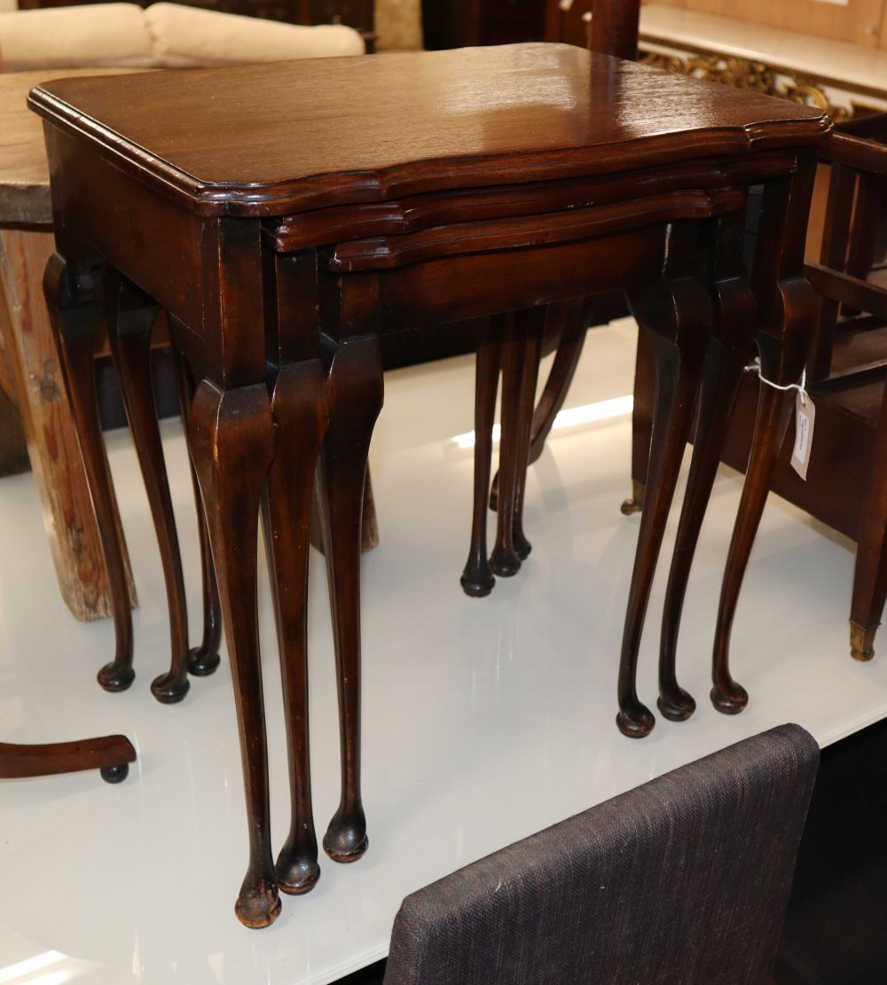 A nest of three tea tables with shaped rectangular tops and cabriole legs